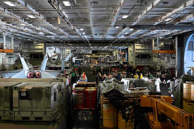 Cargo clogs up the hanger deck of an aircraft carrier.